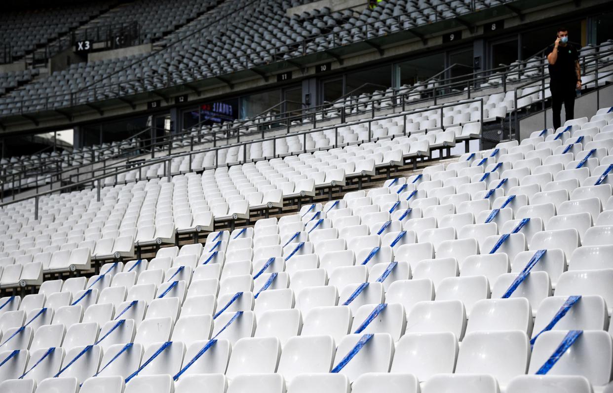 Social distancing signs on the sits of the Stade de France stadium in Saint-Denis, on the outskirts of Paris, on the eve of the French Cup final between Paris Saint-Germain and Saint-Etienne on July 23, 2020, as France eases lockdown measures taken to curb the spread of the COVID-19.