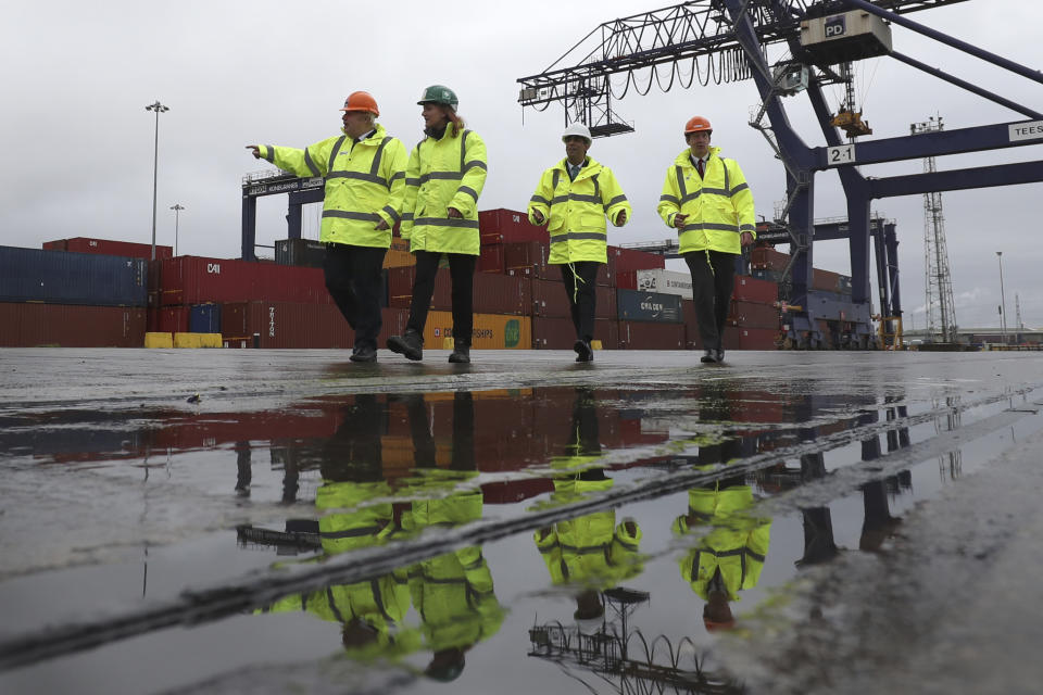 Britain's prime minister Boris Johnson, left, and chancellor of the exchequer Rishi Sunak, second right, walk past shipping containers during a visit to Teesport in Middlesbrough, England, on 4 March. Photo: Scott Heppell/AP