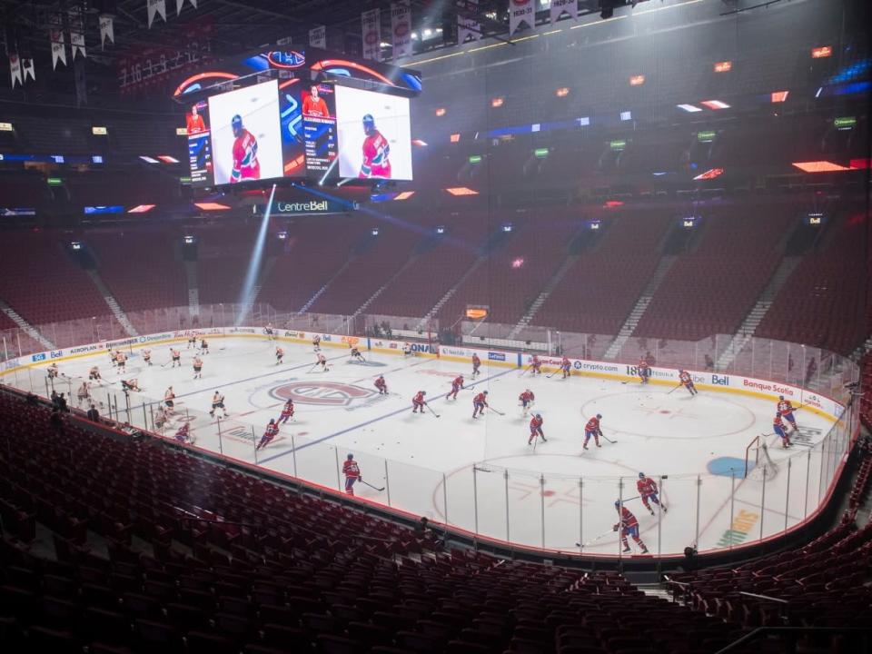 Players from the Montreal Canadiens and the Philadelphia Flyers skate before an empty Bell Centre on Dec. 16. The province of Quebec requested the team play without fans to help curb rising COVID-19 cases. (Graham Hughes/The Canadian Press - image credit)