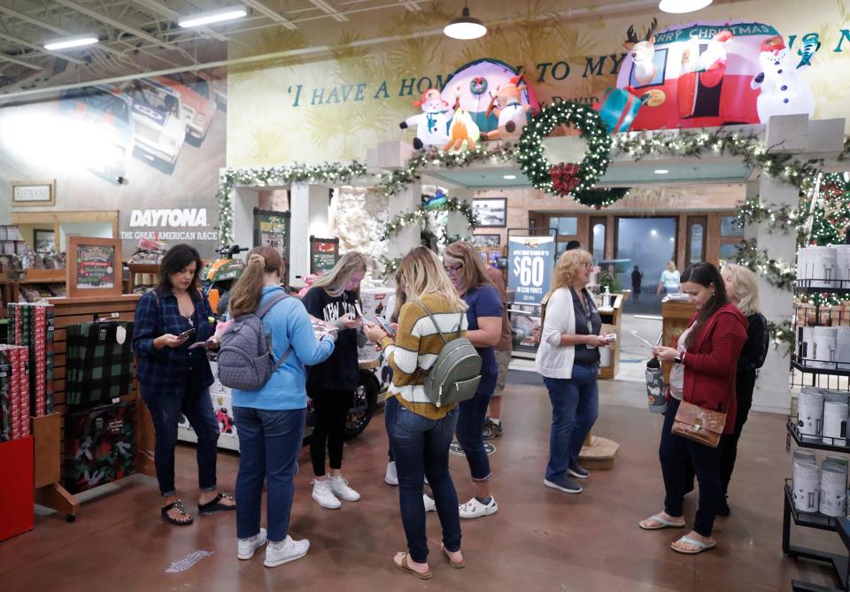 Black Friday shoppers browse bargains at Bass Pro Shops, which opened its doors at 5 a.m. Friday at One Daytona in Daytona Beach. Although lines were shorter at some stores, many shoppers still embrace the traditional pre-dawn retail ritual of Black Friday.