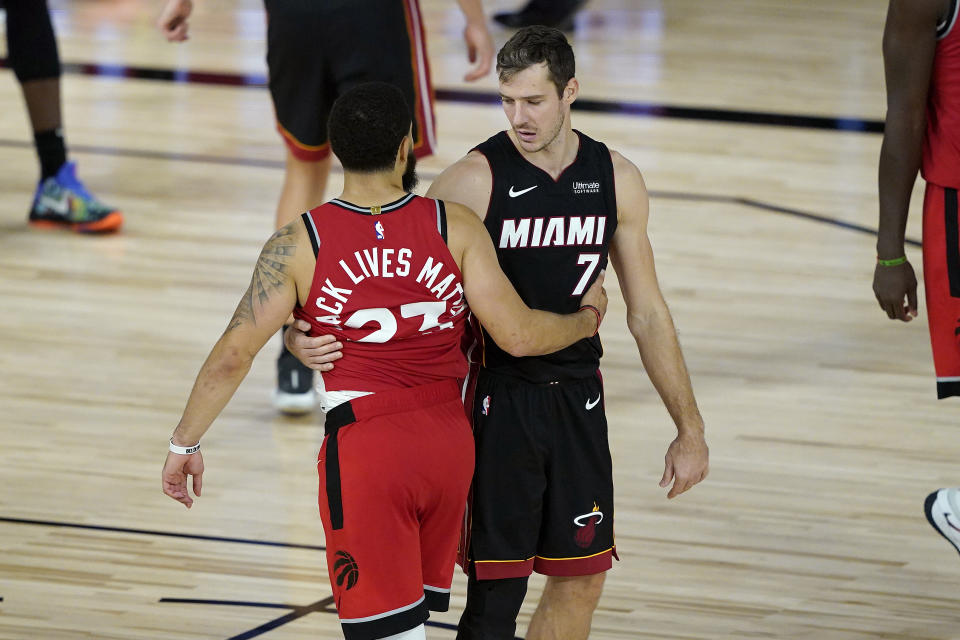 Miami Heat's Goran Dragic (7) greets Toronto Raptors' Fred VanVleet (23) after an NBA basketball game Monday, Aug. 3, 2020, in Lake Buena Vista, Fla. The Raptors won 107-103. (AP Photo/Ashley Landis, Pool)