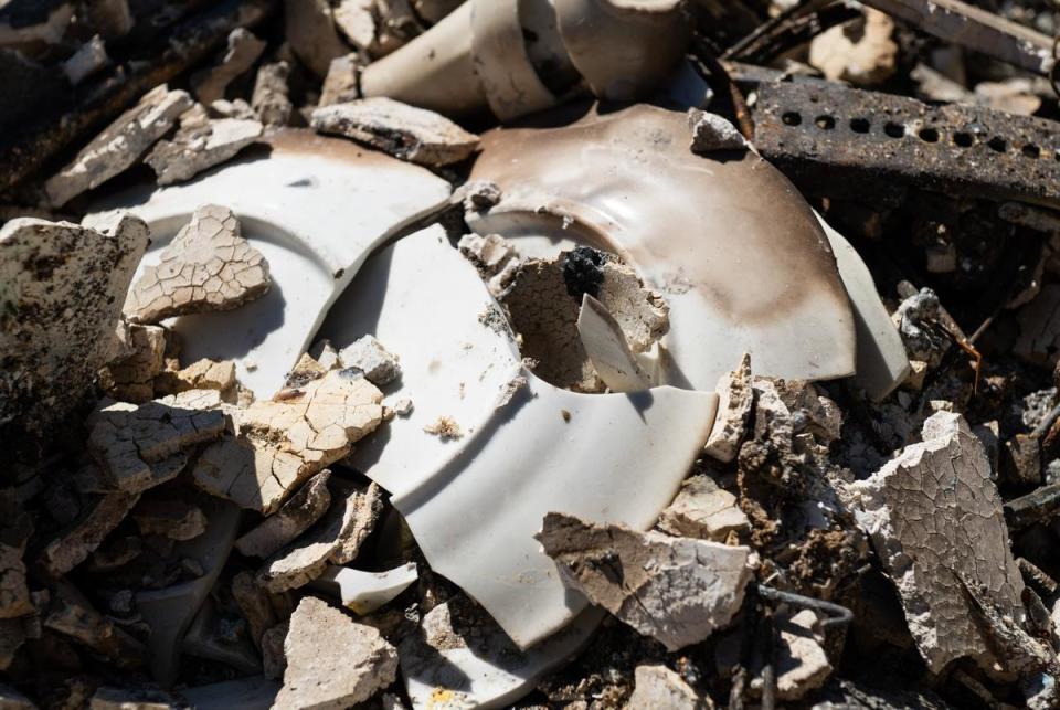 Broken china from Scott McBroom’s mother sits in the rubble of Scott and Deana McBroom’s house Friday, March. 1, 2024, in Fritch, Texas.