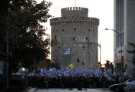 Far-right protesters take part in a rally in front of the White Tower during the annual state of the economy speech by Greece's Prime Minister Kyriakos Mitsotakis in the northern city of Thessaloniki, Greece, Saturday, Sept. 12, 2020. Mitsotakis outlined plans Saturday to upgrade the country's defense capabilities, including purchases of new fighter planes, frigates, helicopters and weapons systems, amid heightened tensions with neighboring Turkey over rights to resources in the eastern Mediterranean. (InTime News via AP)