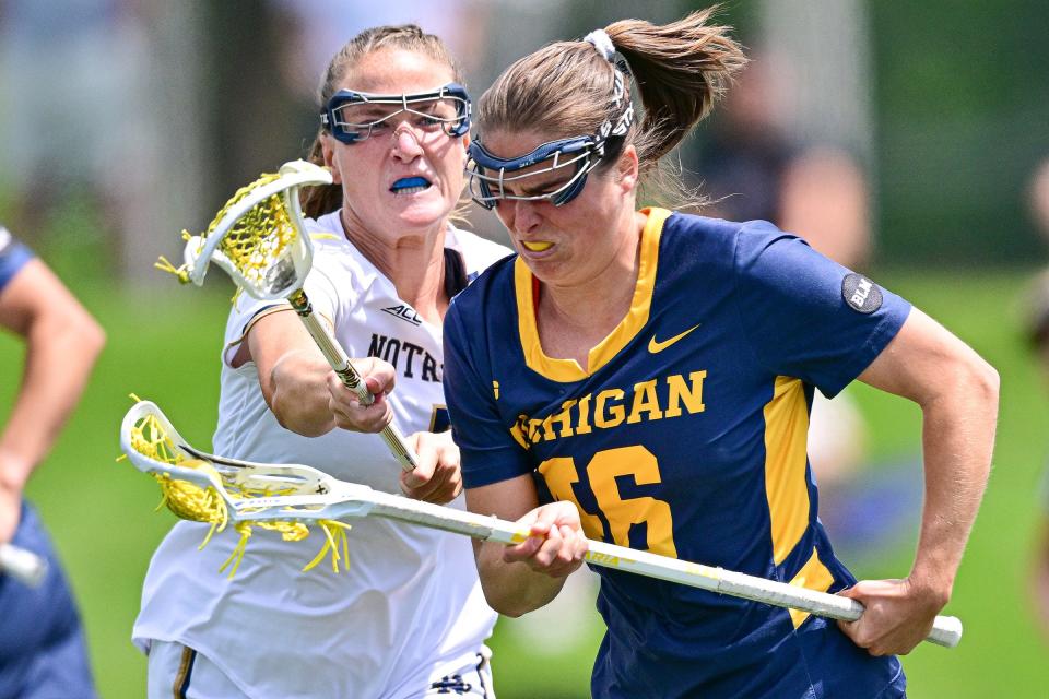 Michigan’s Kassidy Isaacson (16) moves the ball as Notre Dame’s Mary Kelly Doherty (7) defends in the second round NCAA Women’s Lacrosse tournament game Sunday, May 12, 2024, at Arlotta Stadium.