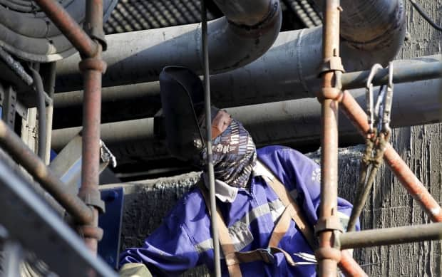 A Chinese mine worker in Eritrea. Experts say foreign fly-in workers are at even greater risk of exploitation and discrimination.