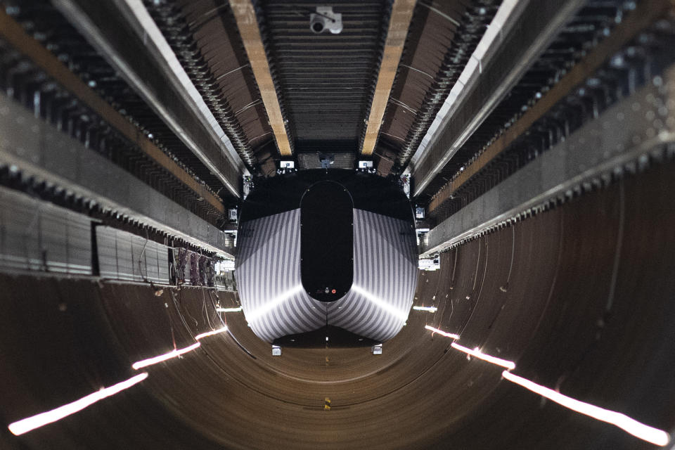 A test vehicle levitated by magnetic fields zips through a depressurized tube in a testing ground for a high-speed transit system during a press tour of a European test center for hyperloop transportation technology in Veendam, northern Netherlands, Friday, Sept. 6, 2024. (AP Photo/Peter Dejong)