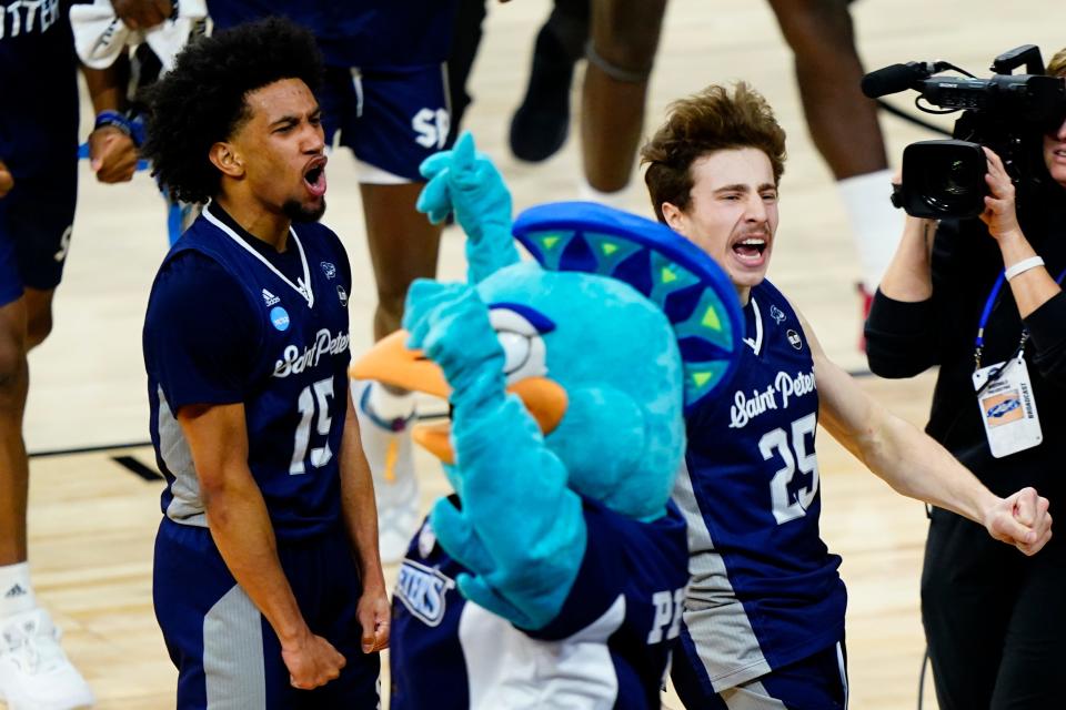 Saint Peter's Matthew Lee, left, and Doug Edert celebrate after Saint Peter's won a college basketball game against Purdue in the Sweet 16 round of the NCAA tournament, Friday, March 25, 2022, in Philadelphia. (AP Photo/Matt Slocum)