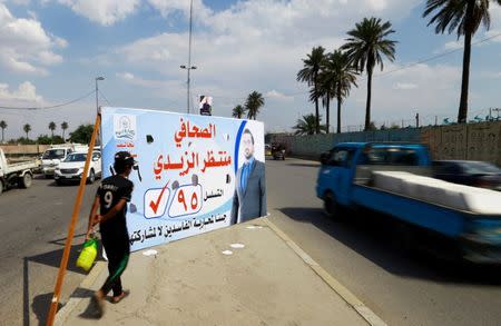 An election poster of Muntazer al-Zaidi, candidate on the Sairun list, is seen in Baghdad, Iraq May 10, 2018. Picture taken May 10, 2018. REUTERS/Thaier al-Sudani