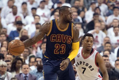 May 23, 2016; Toronto, Ontario, CAN; Cleveland Cavaliers forward LeBron James (23) looks to play a ball as Toronto Raptors guard Kyle Lowry (7) tries to defend during the first quarter in game four of the Eastern conference finals of the NBA Playoffs at Air Canada Centre. Mandatory Credit: Nick Turchiaro-USA TODAY Sports