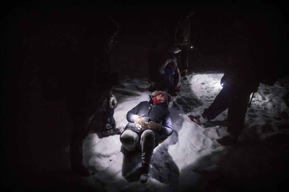 Indian migrant Nishademi, 22, lies exhausted on the snow near the Croatian border as a group of migrants try to enter the EU through Croatia in the mountains surrounding the town of Bihac, northwestern Bosnia on Dec. 12, 2019. (Photo: Manu Brabo/AP)