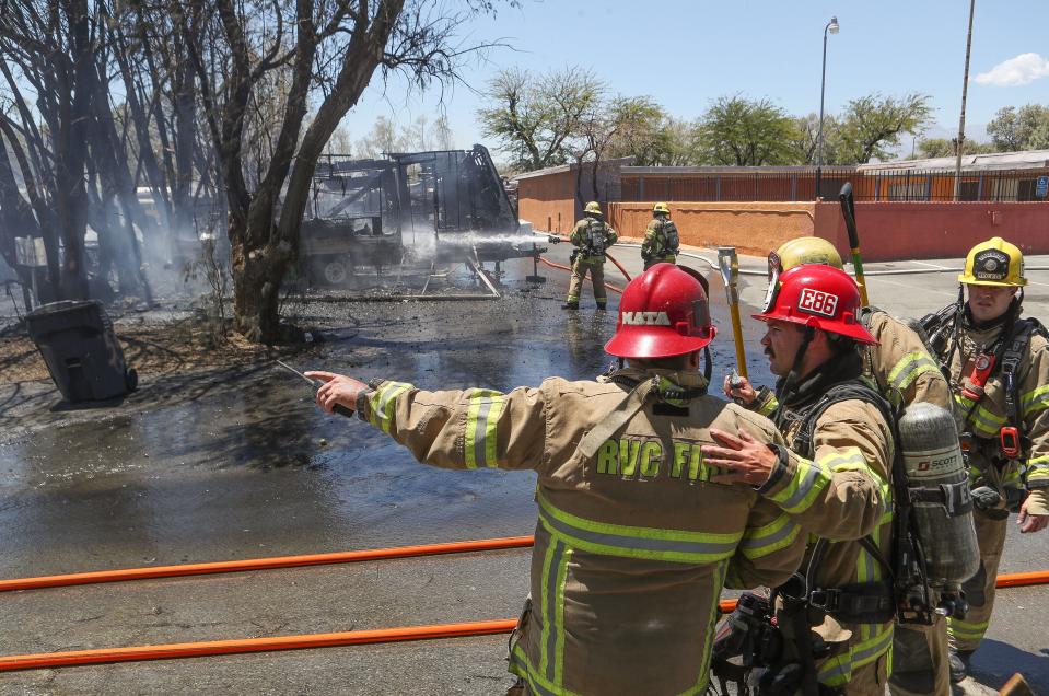 Cal Fire captain Shawn Mata, left, gives direction to others as they battle a fire that destroyed mobile homes at the Country Squire RV and Mobile Home Park in Desert Hot Springs, Calif., July 18, 2023. 