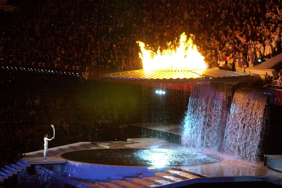 Cathy Freeman holds the Olympic torch at the 2000 Summer Olympics in Sydney, Australia.