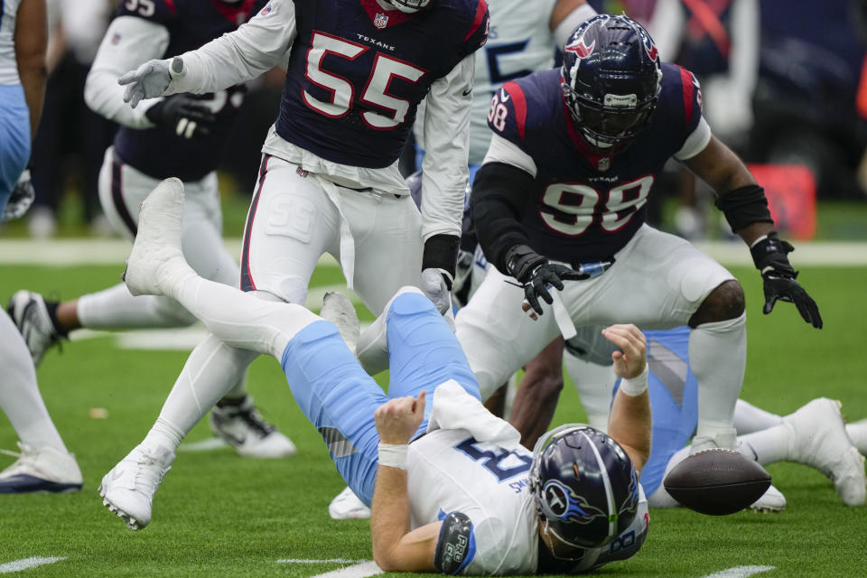 Houston Texans defensive tackle Sheldon Rankins (98) recovers fumble to score a touchdown as Tennessee Titans quarterback Will Levis (8) falls to the turf during the first half of an NFL football game Sunday, Dec. 31, 2023, in Houston. (AP Photo/David J. Phillip)