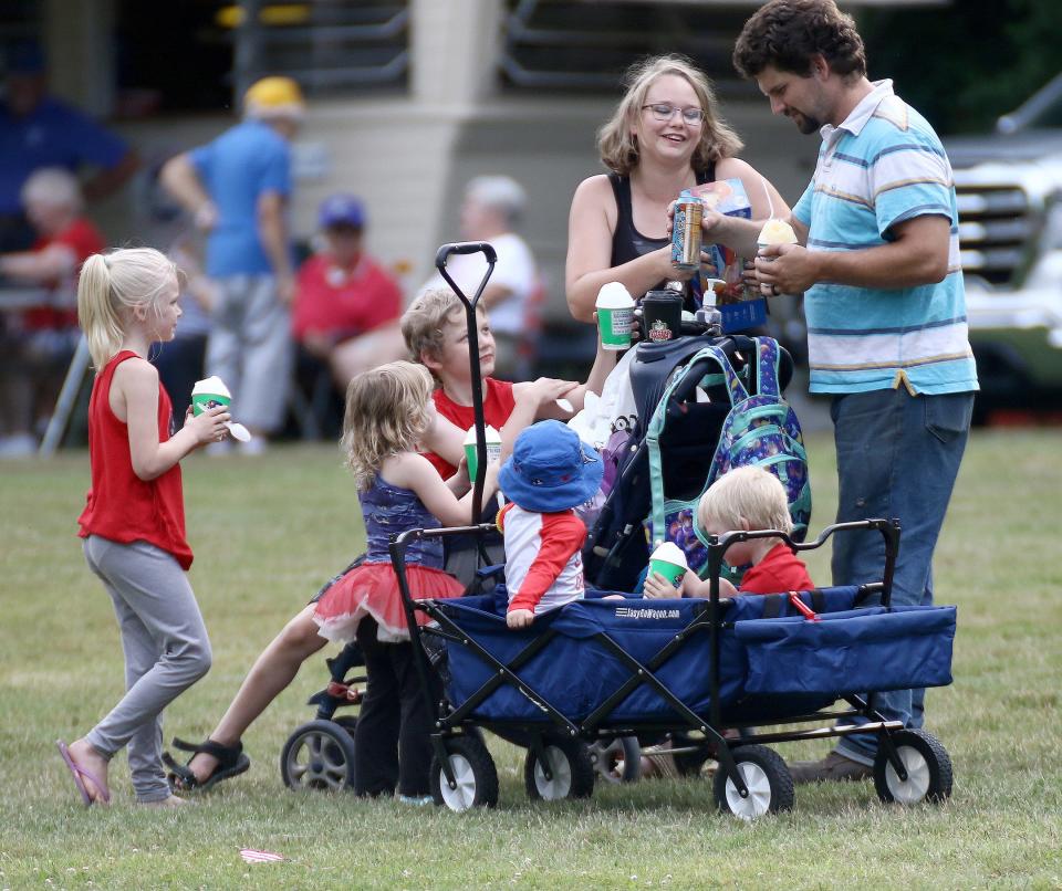 A family celebrates on July 4, 2022, during festivities at Silver Park in Alliance. Shave ice from a food truck was a hit on the hot and humid night.
