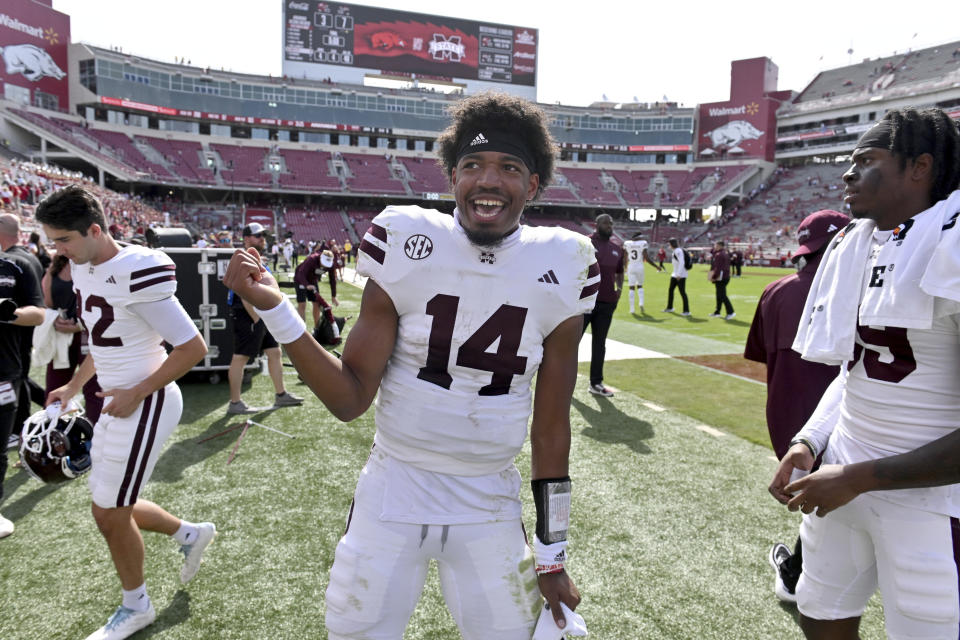 Mississippi State quarterback Mike Wright (14) celebrates with teammates after defeating Arkansas in an NCAA college football game Saturday, Oct. 21, 2023, in Fayetteville, Ark. (AP Photo/Michael Woods)