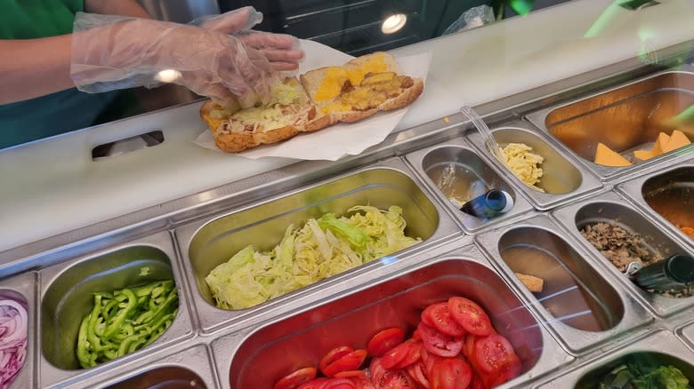 Subway employee making sandwich