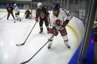 Members of the "1979" hockey club compete during a hockey match at a rink in Beijing, Wednesday, Jan. 12, 2022. Spurred by enthusiasm after China was awarded the 2022 Winter Olympics, the members of a 1970s-era youth hockey team, now around 60 years old, have reunited decades later to once again take to the ice. (AP Photo/Mark Schiefelbein)