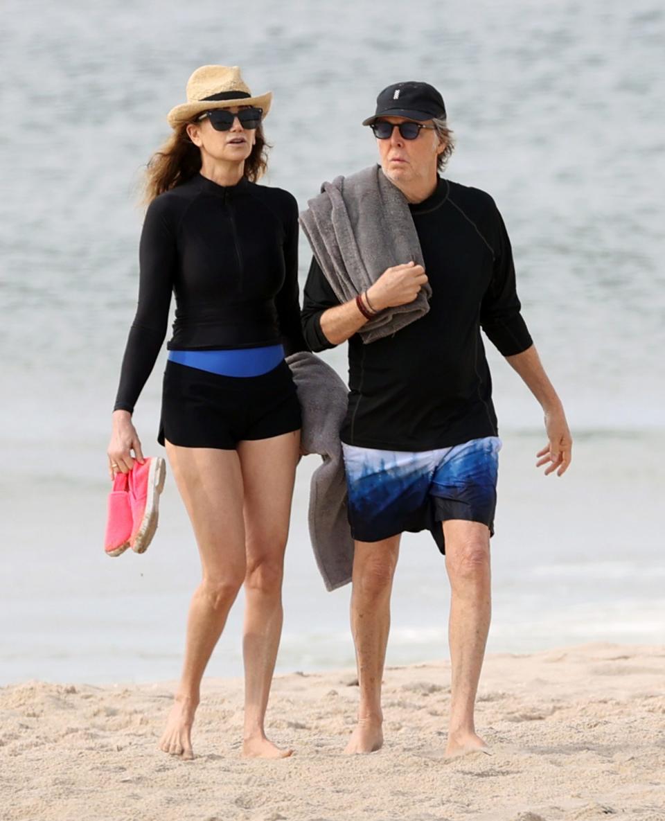 <p>Paul McCartney and wife Nancy Shevell color coordinate on July 29 while strolling along the beach in The Hamptons, New York.</p>