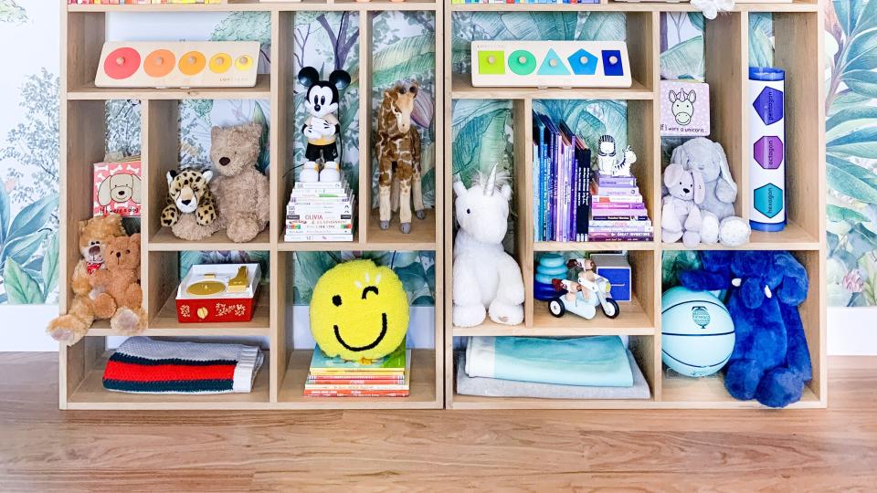 a playroom shelf organized by color from the book stay organized by the home edit