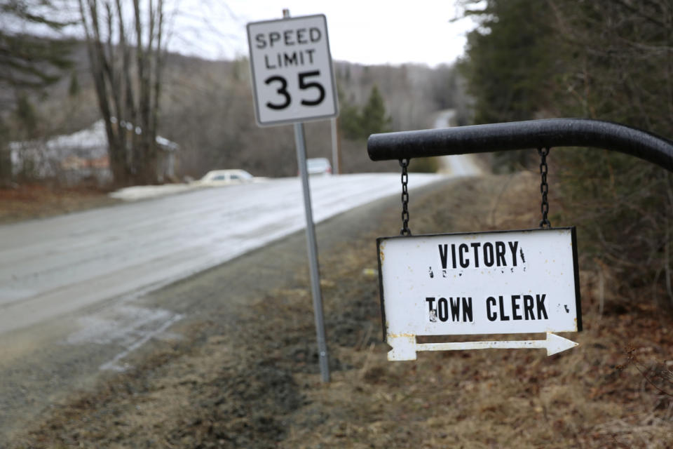 A sign with an arrow points toward the Victory, Vt., Town Clerk's Office, Thursday March 31, 2022. The need to connect homes and businesses to high-speed broadband services was highlighted by the COVID-19 pandemic and officials say that while there is lots of money available, supply and labor shortages are making the expansion a challenge. (AP Photo/Wilson Ring)