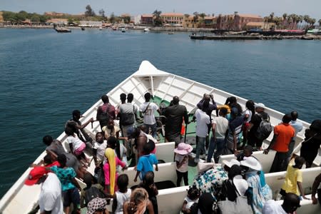 Tourists ride in a ferry towards Goree Island a gathering point from where slaves were shipped west in the 1700s and 1800s, at Goree Island off the coast of Dakar