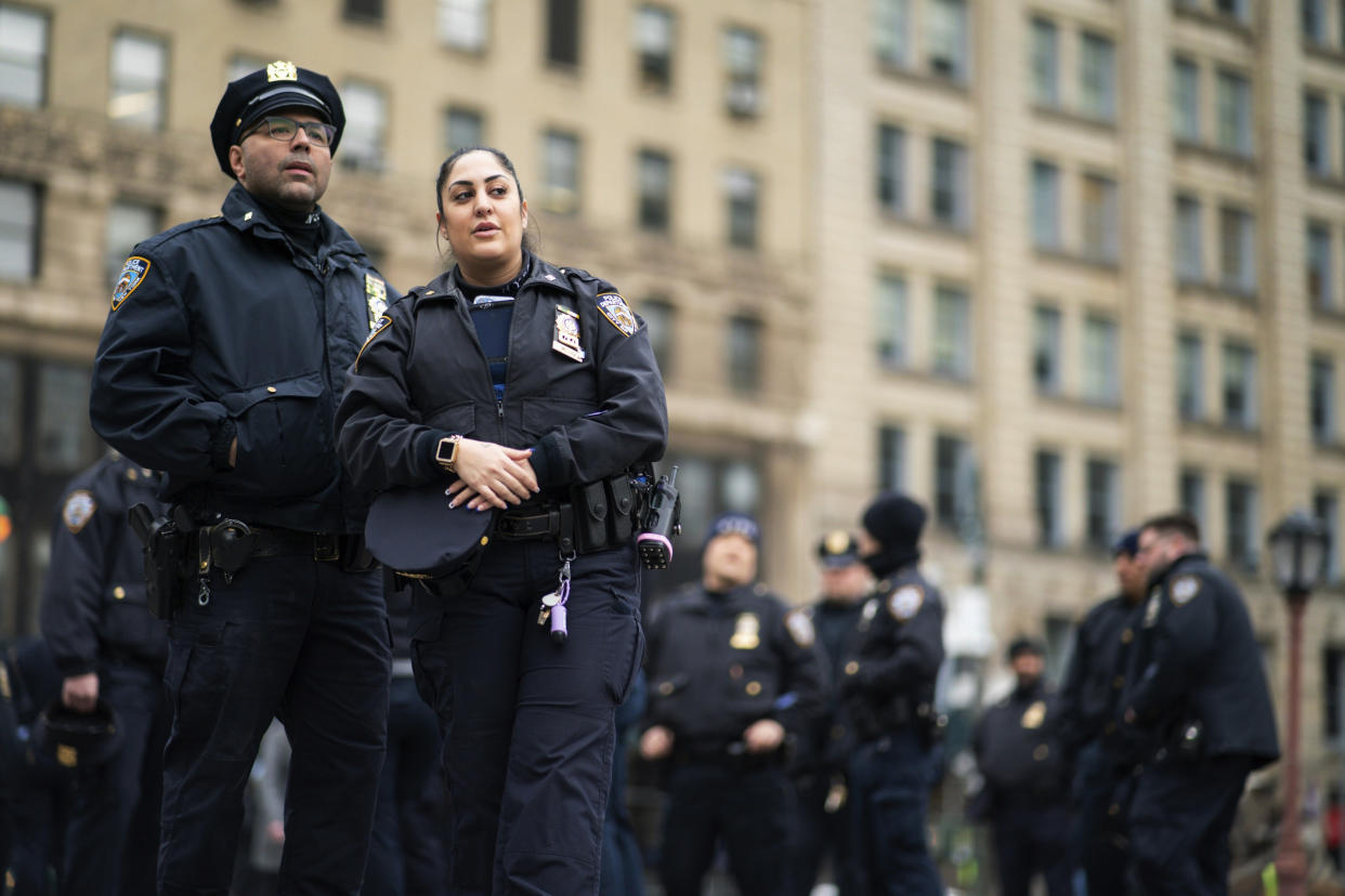 New York Police officers wait for instructions around the courthouse ahead of former President Donald Trump's anticipated indictment on Wednesday, March 22, 2023, in New York. A New York grand jury investigating Trump over a hush money payment to a porn star appears poised to complete its work soon as law enforcement officials make preparations for possible unrest in the event of an indictment.(AP Photo/Eduardo Munoz Alvarez)