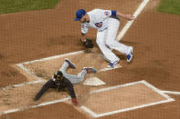 Cleveland Indians' Francisco Lindor (12) slides safely into home around Chicago Cubs starting pitcher Jon Lester during the first inning of a baseball game Wednesday, Sept. 16, 2020, in Chicago. (AP Photo/Mark Black)