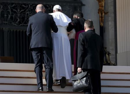 Pope Francis receives help after slipping as he arrives to lead the audience with national Italian insurance body (INPS) in Saint Peter's Square at the Vatican, November 7, 2015. REUTERS/ Alessandro Bianchi