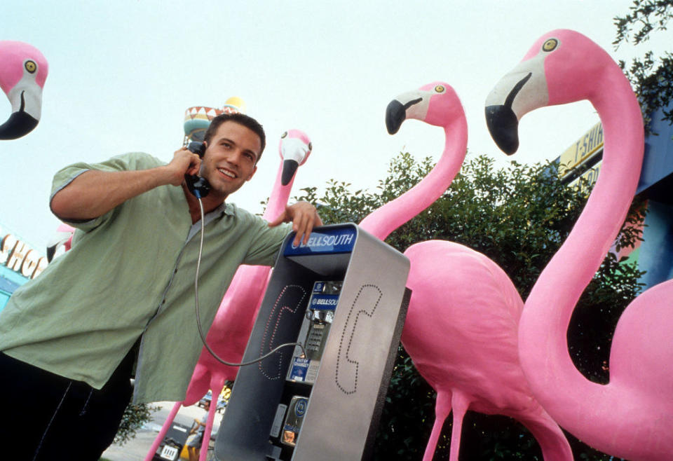 A young man on a pay phone