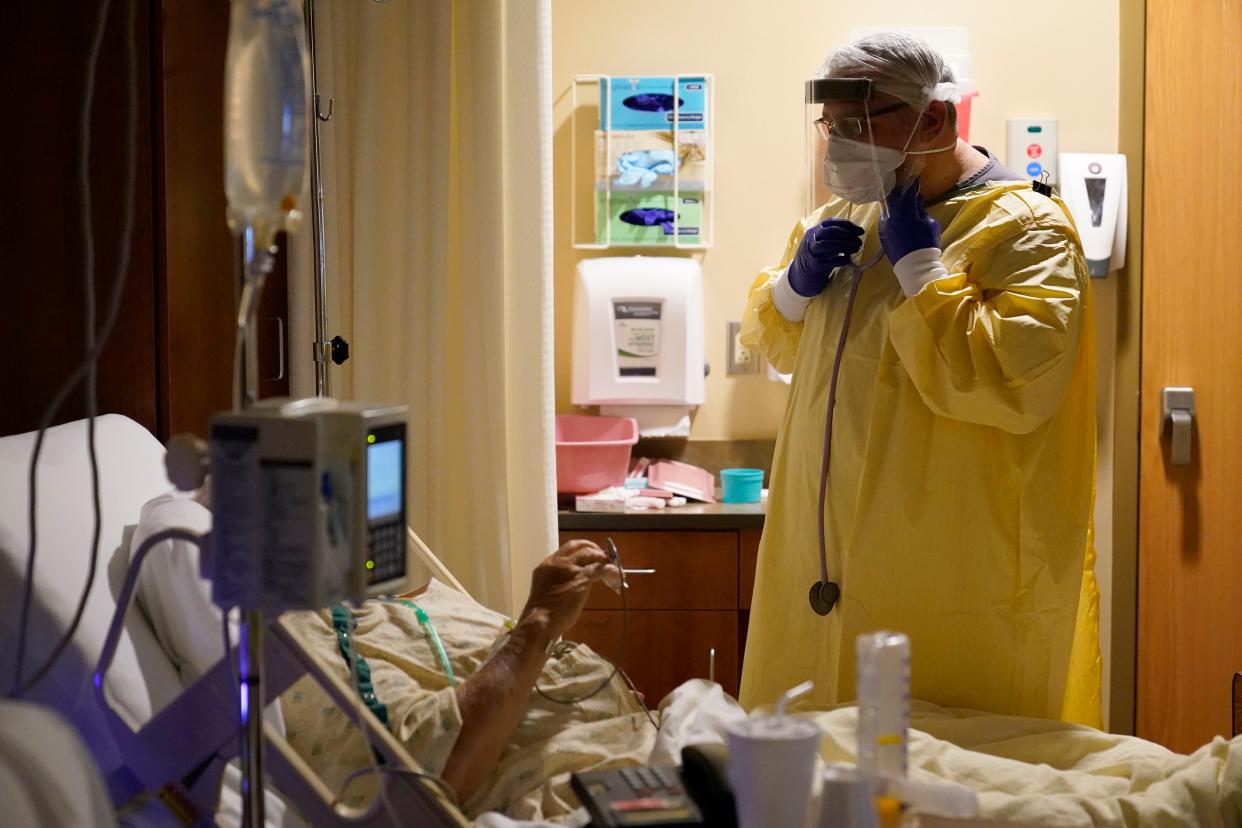 Dr. Shane Wilson performs rounds in a portion of Scotland County Hospital set up to isolate and treat COVID-19 patients Tuesday, Nov. 24, 2020, in Memphis, Mo. The tiny hospital in rural northeast Missouri is seeing an alarming increase in coronavirus cases.