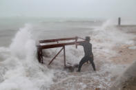 <p>A man tries to salvage a table belonging to his restaurant before the arrival of Hurricane Maria in Punta Cana, Dominican Republic, Sept. 20, 2017. (Photo: Ricardo Rojas/Reuters) </p>