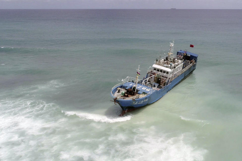 A view of the FV Lu Rong Yuan Yu, a Chinese-flagged fishing vessel that ran aground at Pointe-aux Sables, Port-Louis, Mauritius, Monday, March 8, 2021. Workers in Mauritius have begun pumping 130 tons of fuel from a Chinese fishing vessel that ran aground on a coral reef on the Indian Ocean island’s west coast on Sunday. Local newspaper L’Express reported that the grounded ship has spilled a small amount of fuel into the ocean, but its hull remains intact. (L'express Maurice via AP)