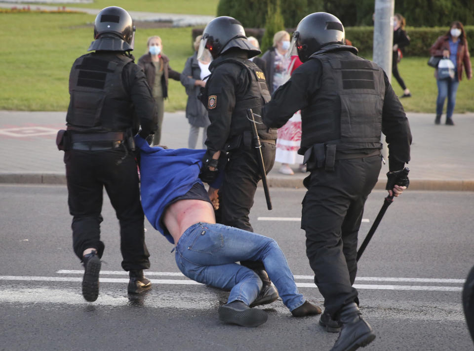 Riot police detain a protester during an opposition rally to protest the presidential inauguration in Minsk, Belarus, Wednesday, Sept. 23, 2020. Belarus President Alexander Lukashenko has been sworn in to his sixth term in office at an inaugural ceremony that was not announced in advance amid weeks of huge protests saying the authoritarian leader's reelection was rigged. Hundreds took to the streets in several cities in the evening to protest the inauguration. (AP Photo/TUT.by)