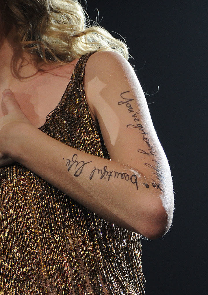closeup of the lyrics written down taylor's arm