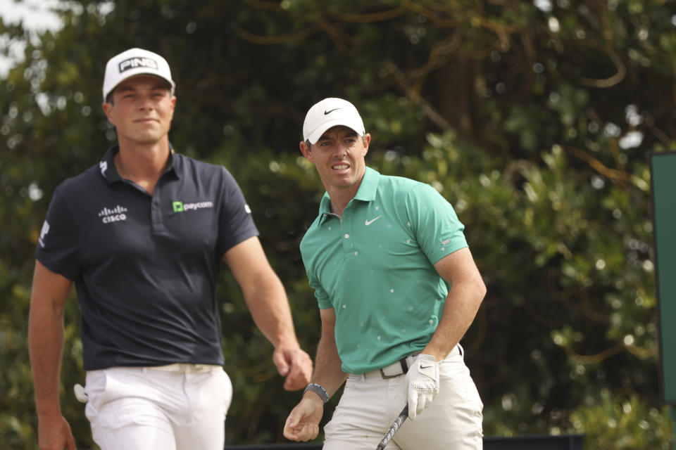 Rory McIlroy of Northern Ireland watches his shot from the 3rd tee with Viktor Hovland, of Norway, during the third round of the British Open golf championship on the Old Course at St. Andrews, Scotland, Saturday July 16, 2022. (AP Photo/Peter Morrison)