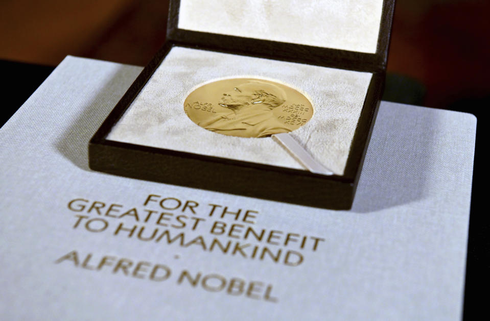 FILE - The Nobel diploma and medal in physiology or medicine presented to Charles M. Rice is displayed, Tuesday, Dec. 8, 2020, during a ceremony in New York. This year’s Nobel season approaches as Russia’s invasion of Ukraine has shattered decades of almost uninterrupted peace in Europe and raised the risks of a nuclear disaster. The famously secretive Nobel Committee never leaks or hints who will win its prizes for medicine, physics, chemistry, literature, economics or peace. So it is anyone’s guess who might win the awards that will be announced starting next Monday, Oct. 3, 2022. (Angela Weiss/Pool Photo via AP, File)