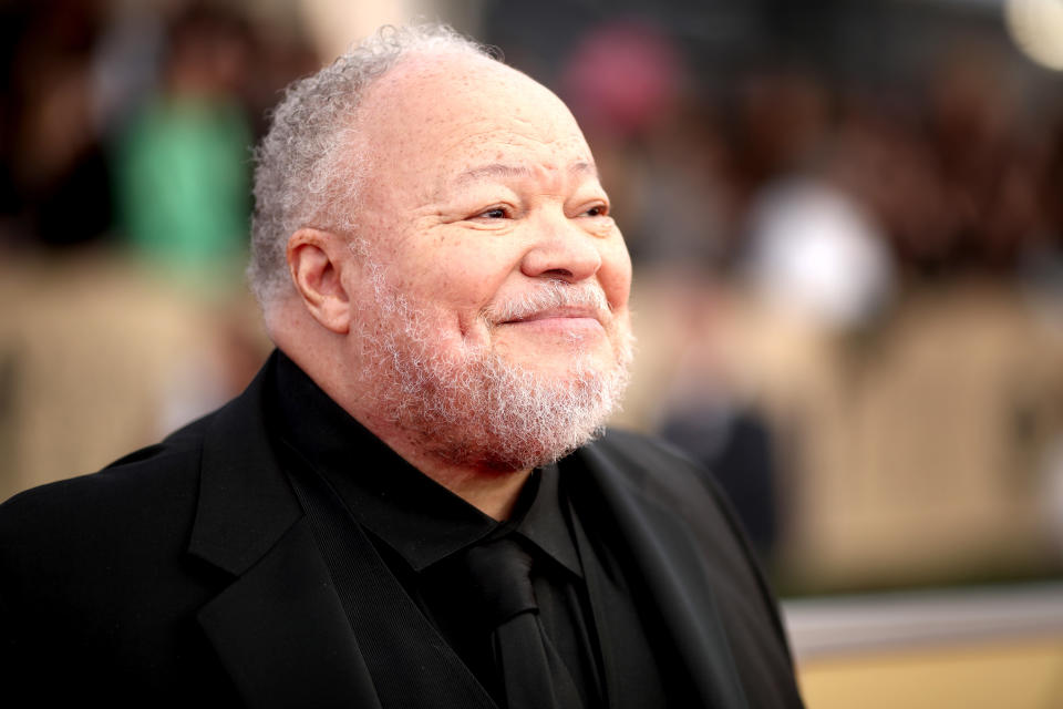 Stephen Henderson wearing a black blouse.