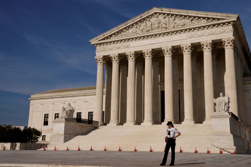 FILE PHOTO: A U.S. Supreme Court police officer patrols the plaza in front the court building in Washington