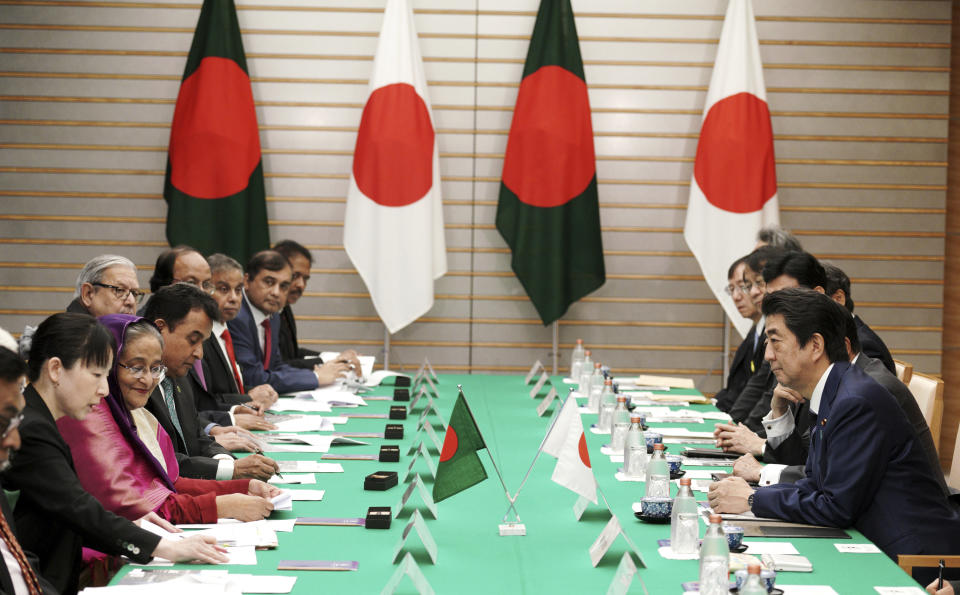 Bangladesh's Prime Minister Sheikh Hasina, third from left, and Japan's Prime Minister Shinzo Abe, right, attend their meeting at Abe's official residence Wednesday, May 29, 2019, in Tokyo. Hasina is wooing Japan for aid, trade and investment in a visit that highlights cordial relations with the administration of Abe. (AP Photo/Eugene Hoshiko, Pool)