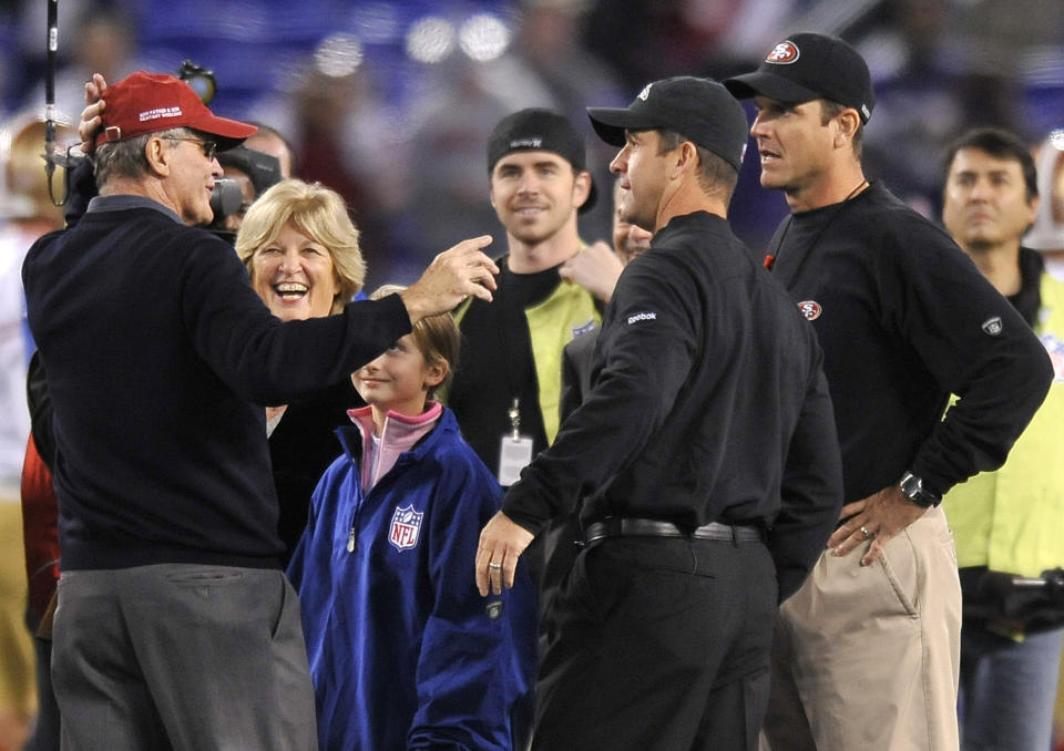 FILE - In this Nov. 24, 2011 file photo, Jack Harbaugh, far left, and his wife Jackie, second from left, chat with sons Baltimore Ravens head coach John Harbaugh, second from right, and San Francisco 49ers head coach Jim Harbaugh before an NFL football game in Baltimore. The entire Harbaugh family already got its Super Bowl victory last Sunday, when each coach did his part to ensure a family reunion in New Orleans next week. The Ravens face off against the 49ers in the first Super Bowl coached by siblings on opposite sidelines. (AP Photo/Gail Burton, File)