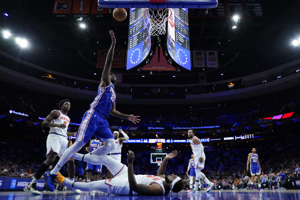 Philadelphia 76ers' Joel Embiid goes up for a shot over New York Knicks' Mitchell Robinson during the first half of Game 3 in an NBA basketball first-round playoff series, Thursday, April 25, 2024, in Philadelphia. (AP Photo/Matt Slocum)