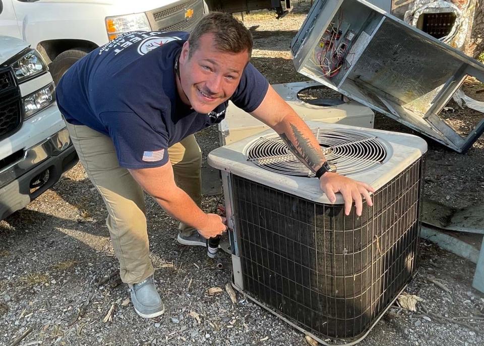 All muscle, Paxton Poteet moves an HVAC unit out of the way at Poteet Heat and Air in Karns Tuesday, June 21, 2022.