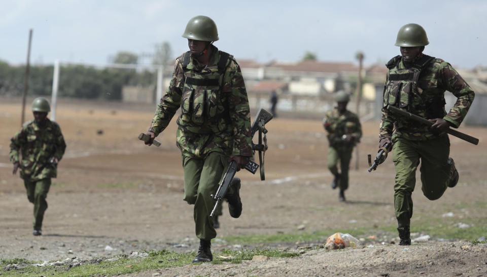 <p>Police run during clashes with opposition supporters in the Jacaranda grounds quarter in Nairobi, Kenya, Tuesday, Nov. 28, 2017. (Photo: Brian Inganga/AP) </p>