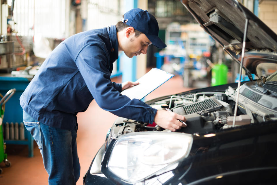 A mechanic at work in his garage. (Source: Getty)