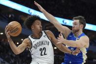 Brooklyn Nets' Jalen Wilson passes around Milwaukee Bucks' Pat Connaughton during the first half of an NBA basketball game Thursday, March 21, 2024, in Milwaukee. (AP Photo/Morry Gash)