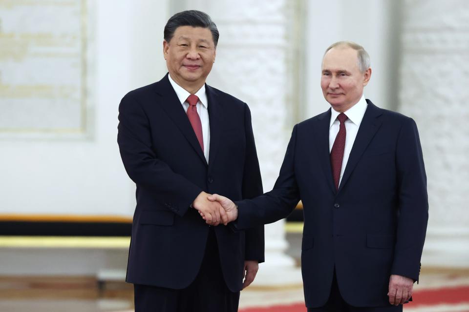 Russian President Vladimir Putin, right, and Chinese President Xi Jinping pose for a photo during an official welcome ceremony at The Grand Kremlin Palace, in Moscow, Russia, Tuesday, March 21, 2023. (Sergei Karpukhin, Sputnik, Kremlin Pool Photo via AP)