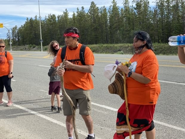 James Henyu, centre left, and Jacqueline Shorty, right, with a group of local supporters last month, right before leaving Whitehorse on their walk to Kamloops, B.C. (Chris MacIntyre/CBC - image credit)