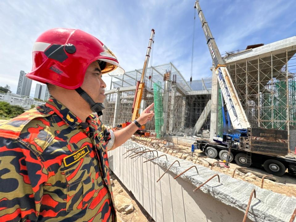 Deputy state Fire and Rescue Department director Fire Assistant Commissioner Zulfahmi Sutaji showing the site of the collapse. — Picture courtesy of Fire And Rescue Department