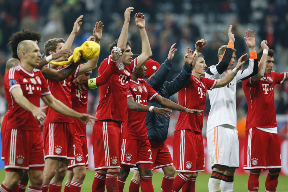 Bayern players celebrate advancing to the quarterfinal after the Champions League round of 16 second leg soccer match between FC Bayern Munich and FC Arsenal in Munich, Germany, Wednesday, March 12, 2014. (AP Photo/Matthias Schrader)