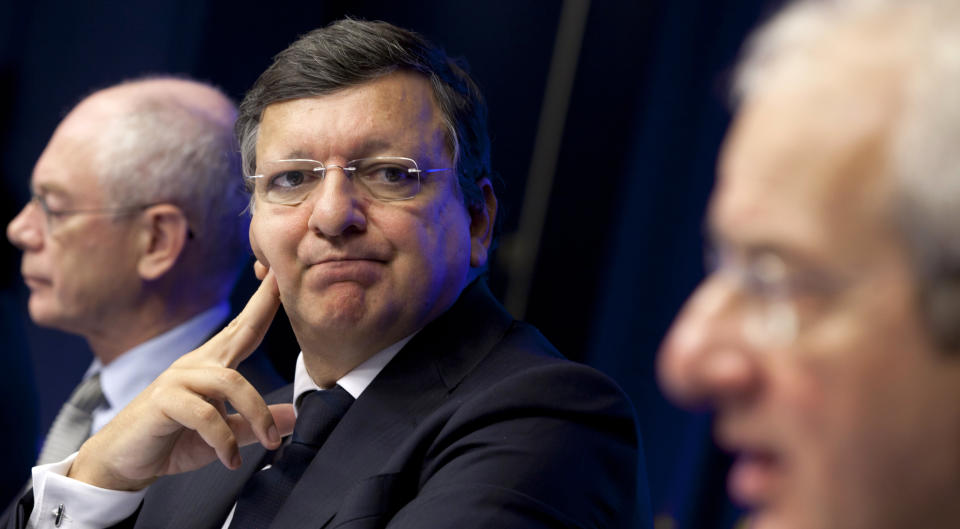 European Commission President Jose Manuel Barroso, center, looks at Director General of Business Europe Philippe de Buck during a media conference at an EU summit in Brussels on Thursday, Oct. 18, 2012. European leaders are gathering again in Brussels to discuss how to save the euro currency from collapse and support countries facing too much debt and not enough growth. At left is European Council President Herman Van Rompuy. (AP Photo/Virginia Mayo)